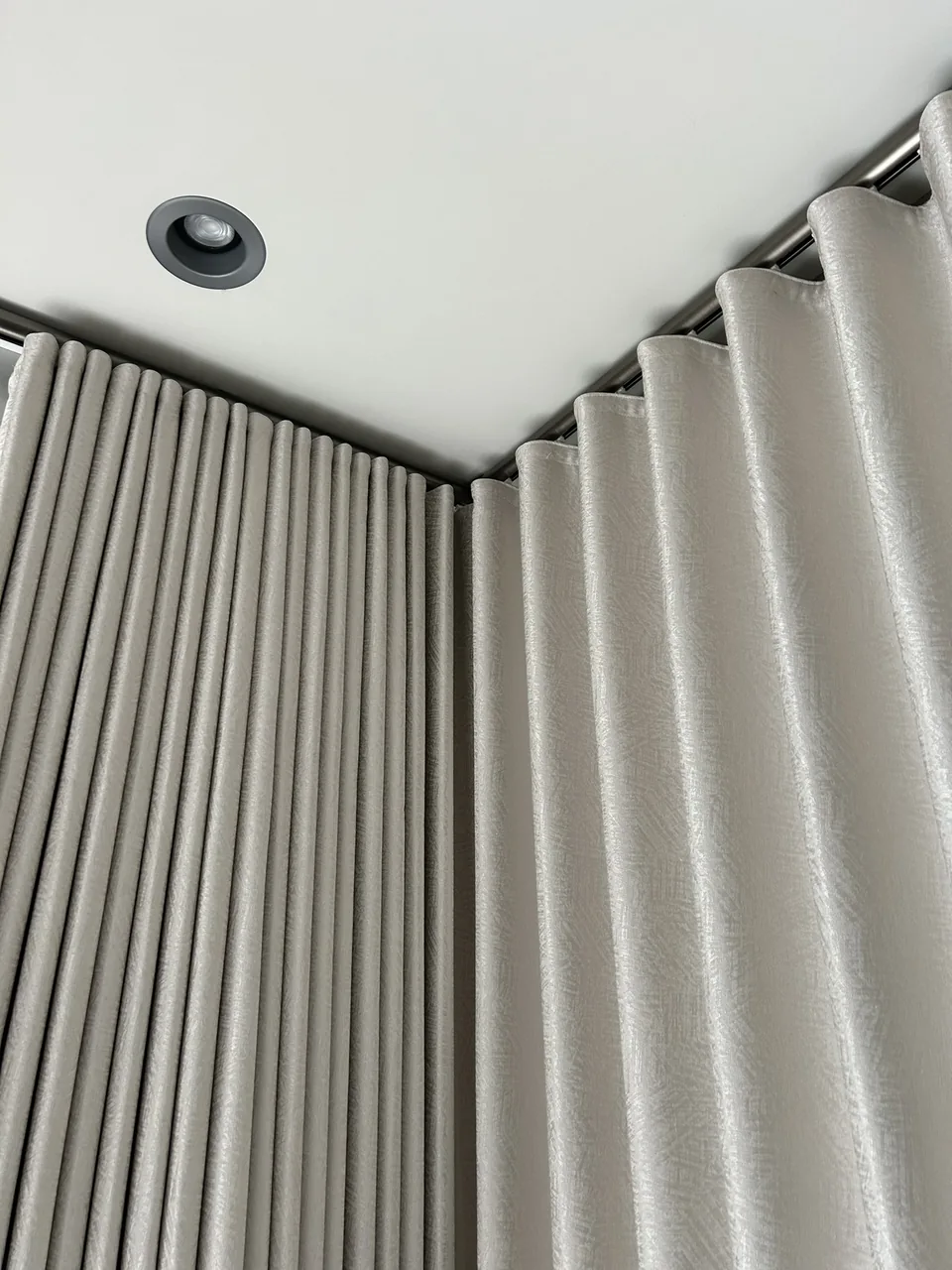 Curtain folds at a ceiling corner